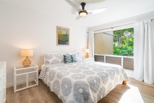 a bedroom with a bed and a window at Pali Ke Kua #204 in Princeville