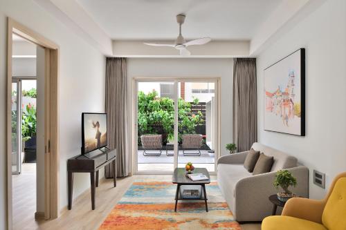 a living room with a couch and a table at Citadines Arpora Nagoa Goa in Arpora