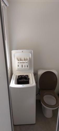 a small kitchen with a stove and a toilet at le lac des rêves in Lattes