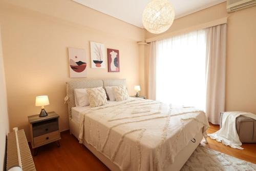 a bedroom with a large bed and a window at AnyfApartment Kalamata in Kalamata