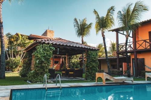 a house with a swimming pool in front of a house at Pousada Meeting Point & KiteSchool in Cumbuco
