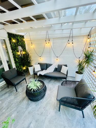 a patio with couches and chairs and plants at Aici te simți ca acasa 2 in Iaşi