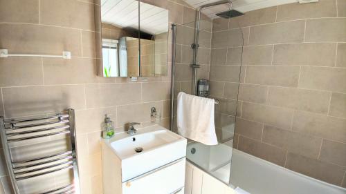 a bathroom with a sink and a mirror at New Holiday Let in Skipton, North Yorkshire in Skipton
