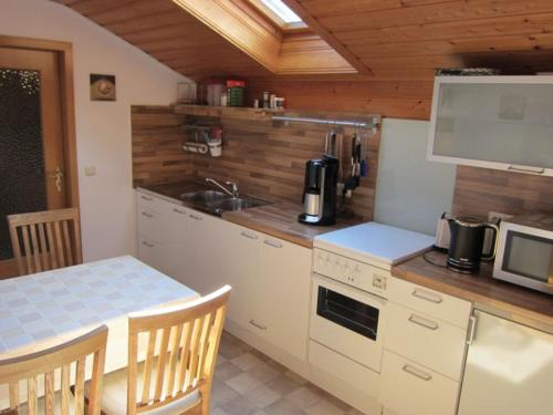 a kitchen with a table and a counter top at Ferienwohnung Enzinger in Teisendorf