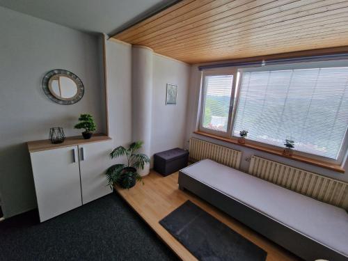 a living room with a couch and a window at Penzion ALICE in Zlín