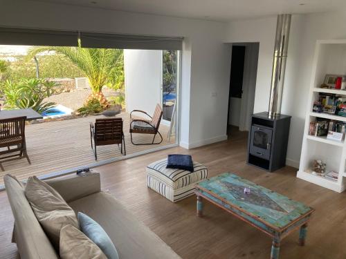 un soggiorno con divano e tavolo di Majanicho Rock - villa with heated pool a Lajares