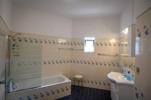 a bathroom with a tub and a sink at EastView Lagos in Lagos