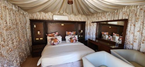 a bedroom with a large bed and a mirror at Go bedouin camp in Wadi Rum