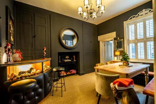 a living room with a table and a fireplace at 42 is the Answer- Stunning York townhouse appearing on TV Holiday Home Show in York