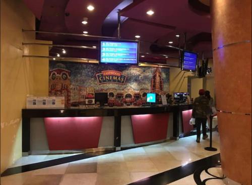 a person standing at a counter in a fast food restaurant at Elegant 2BR, 2 BA Suite Beside Eastwood Mall in Manila