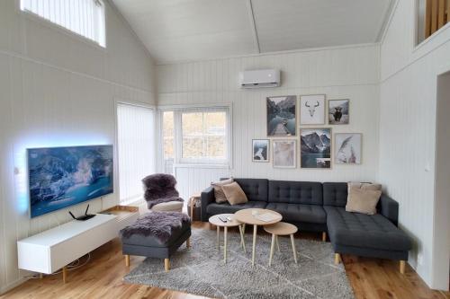 a living room with a couch and a table at Lovely home by Glomma river! in Vidnes