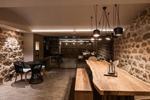 a dining room with wooden tables and chairs at Kera Neme in Neméa