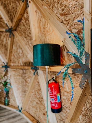 a lamp on a wall in a room at Natura Glamping in Alcongosta