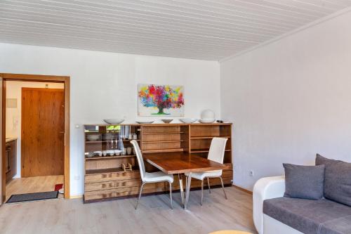a living room with a table and a couch at Haus Excelsior Top 17 in Seefeld in Tirol