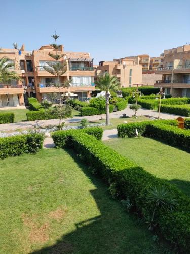 a park in a city with bushes and buildings at Blumar Sidi Abdel Rahman 2 bedrooms Chalet North Coast in El Alamein