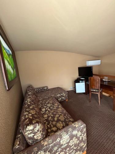 a living room with a couch and a table at Penzion Benedikti in Prievidza