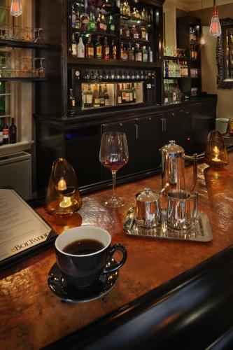 a bar with a cup of coffee and a glass of wine at Inn on Boltwood in Amherst