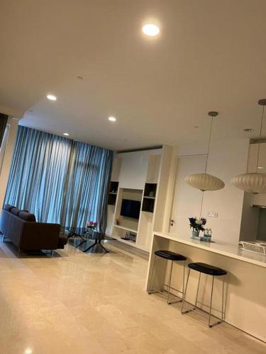 a living room with a couch and a table and chairs at KLCC Sky Villa Suites Platinum in Kuala Lumpur