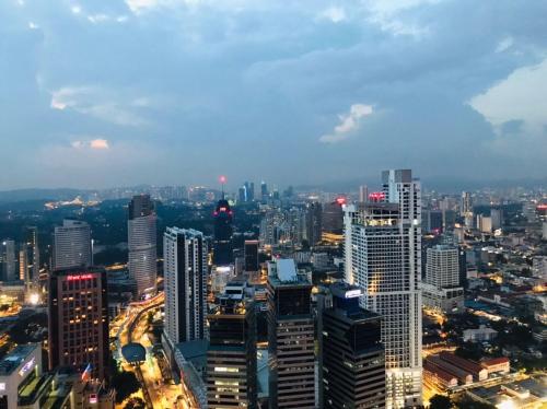 a view of a city skyline at night at KLCC Sky Villa Suites Platinum in Kuala Lumpur