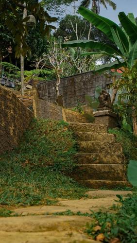 a set of stone stairs in a garden at Sebatu Tulen Villa in Tegalalang