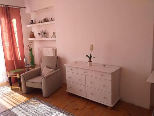 a living room with a dresser and a chair at zielone Bemowo zaprasza in Warsaw