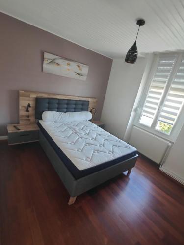 - une chambre avec un lit dans un dortoir doté de parquet dans l'établissement le Cozy Nest, à Gérardmer