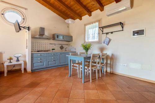 a kitchen with a blue table and chairs at L'Oro Rosso in Marostica