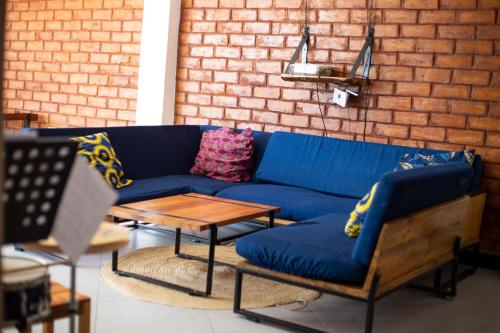 a blue couch and a table in a room at Mountain View Town House in Iringa