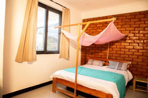 a bedroom with a bed with a canopy bed at Mountain View Town House in Iringa