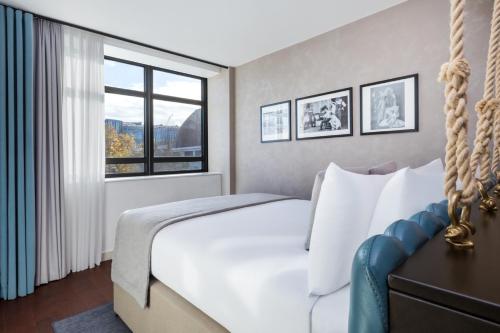 a bedroom with a white bed and a window at Hotel Indigo London - 1 Leicester Square by IHG in London