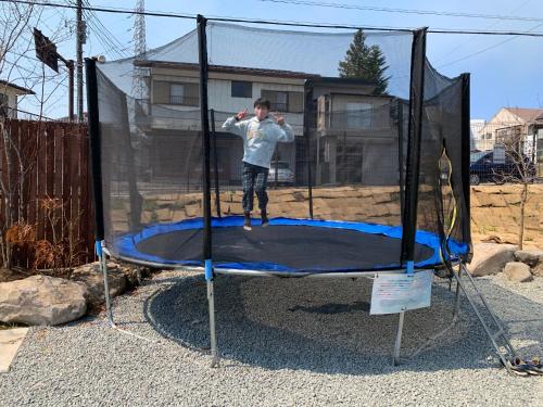 a man standing on top of a trampoline at MIYABI Highland Terrace Villa B in Fujiyoshida