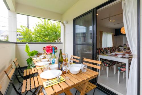 a balcony with a wooden table and chairs at MIYABI Highland Terrace Villa B in Fujiyoshida
