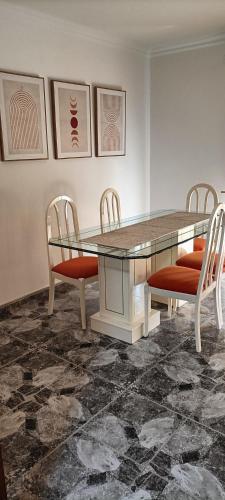 a dining room with a glass table and chairs at Coral in Los Abrigos