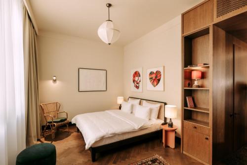 a bedroom with a bed and a book shelf at Boutique Hotel Château Royal in Berlin