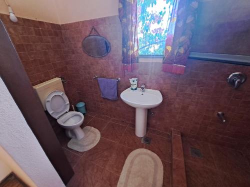 a bathroom with a toilet and a sink at Defora holiday in Žrnovo