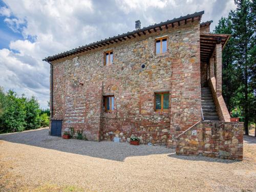 a brick building with a staircase on the side of it at Idyllic Farmhouse in Gambassi Terme Fi with Swimming Pool in Querce