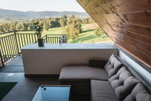 a living room with a couch on a balcony at Dusza Beskidów in Żywiec