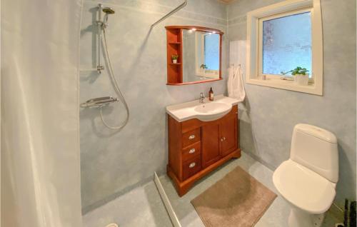 a bathroom with a shower and a sink and a toilet at Nice Home In Bstad With Wifi And 3 Bedrooms in Båstad