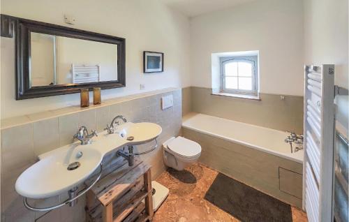 a bathroom with a sink and a tub and a toilet at Amazing Home In Ouveillan With Outdoor Swimming Pool And 5 Bedrooms in Ouveillan