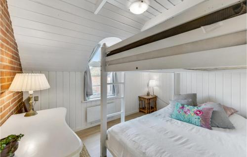 a bedroom with a bed and a loft bed at Nice Home In Ringkbing With Sauna in Klegod