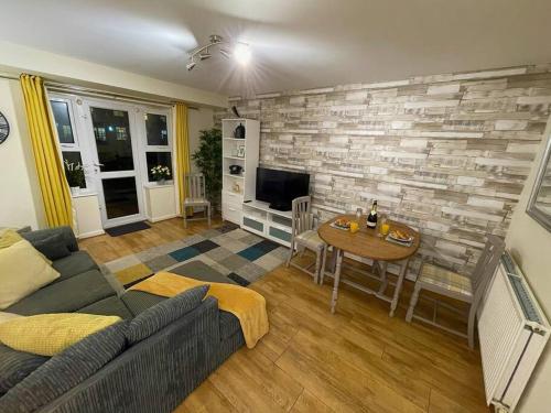 a living room with a couch and a table at Modern 2-Bed Home Free Parking Perfect for Families in Loughborough
