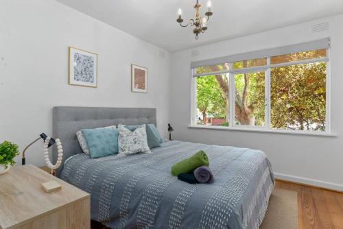 a bedroom with a large bed and a window at Enjoy The Esplanade's Treats From Acland Street in Melbourne