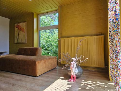 a bedroom with a bed and a vase on the floor at Holiday home in rural area with private garden in Leende