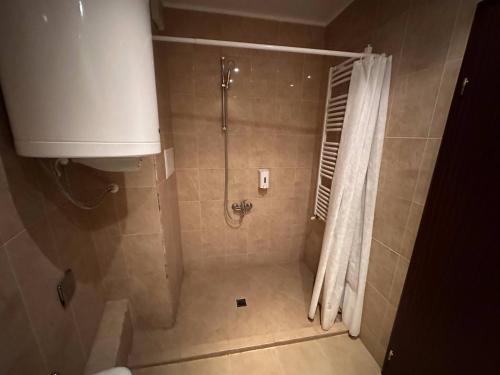 a bathroom with a shower with a shower curtain at 2br Mountain View Apartment - 250mbps Wifi in Bansko