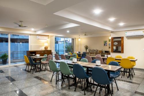 a dining room with tables and chairs at Perch Arbor Cyber City in Gurgaon