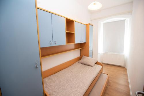 a small room with a bed and a window at Newly adapted 3-room apartment in Postojna