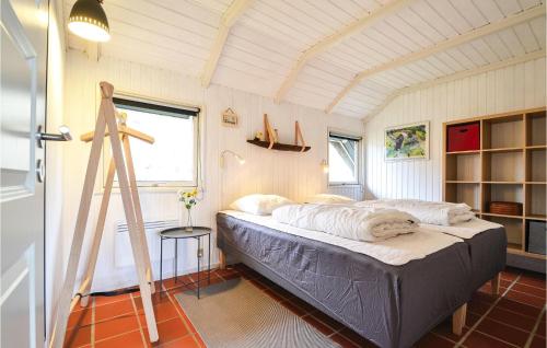 a bedroom with a bed and a ladder in it at 2 Bedroom Awesome Home In Hvide Sande in Havrvig