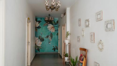 a hallway with a mural of flowers on the wall at Stay Banaras - A Boutique Hotel in Varanasi