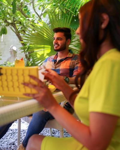 a man and a woman sitting at a table at Stay Banaras - A Boutique Hotel in Varanasi