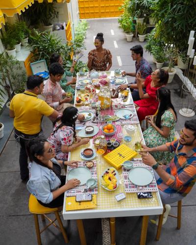 a group of people sitting around a table eating food at Stay Banaras - A Boutique Hotel in Varanasi